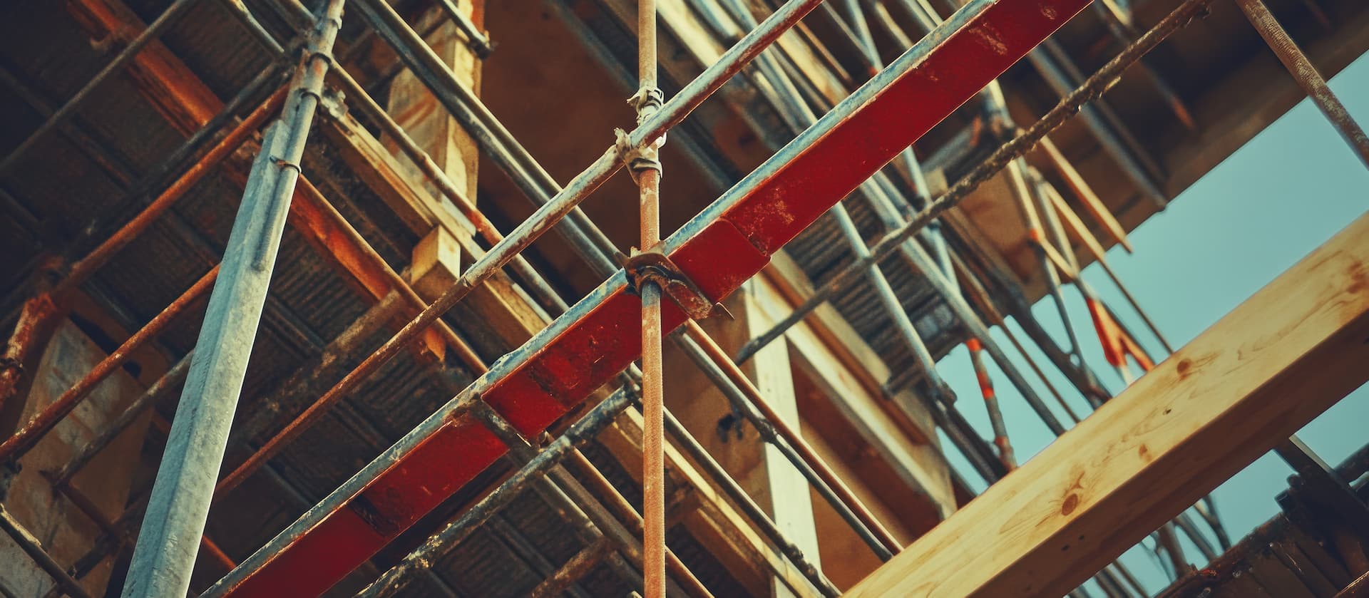 scaffolding on a building with a wooden beam and a wooden beam