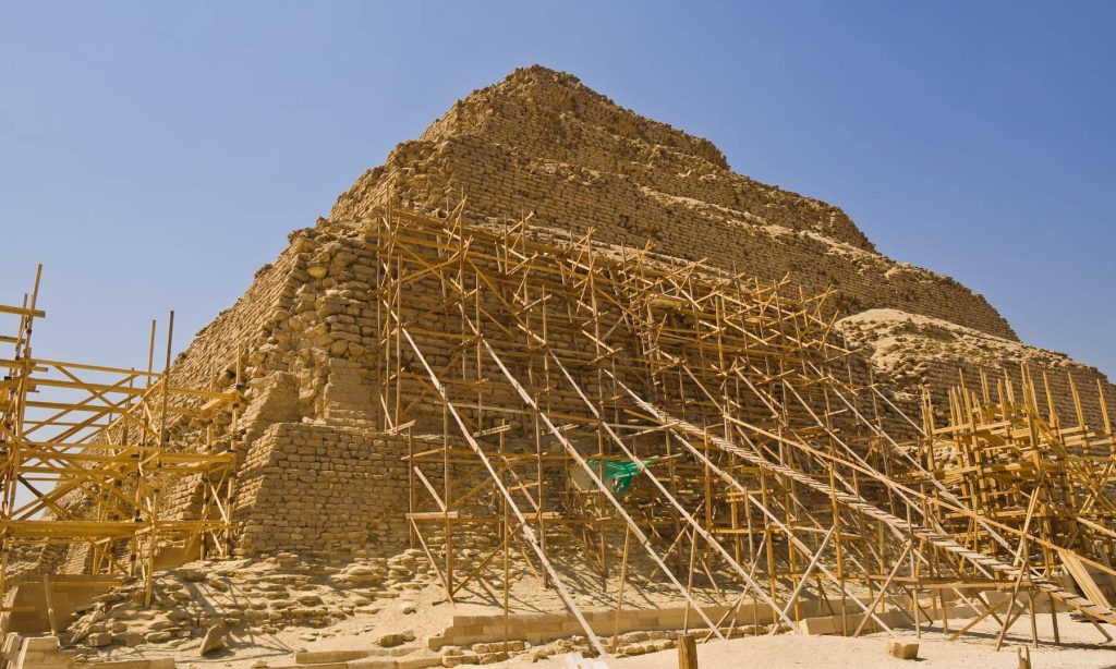 a stone pyramid with scaffolding