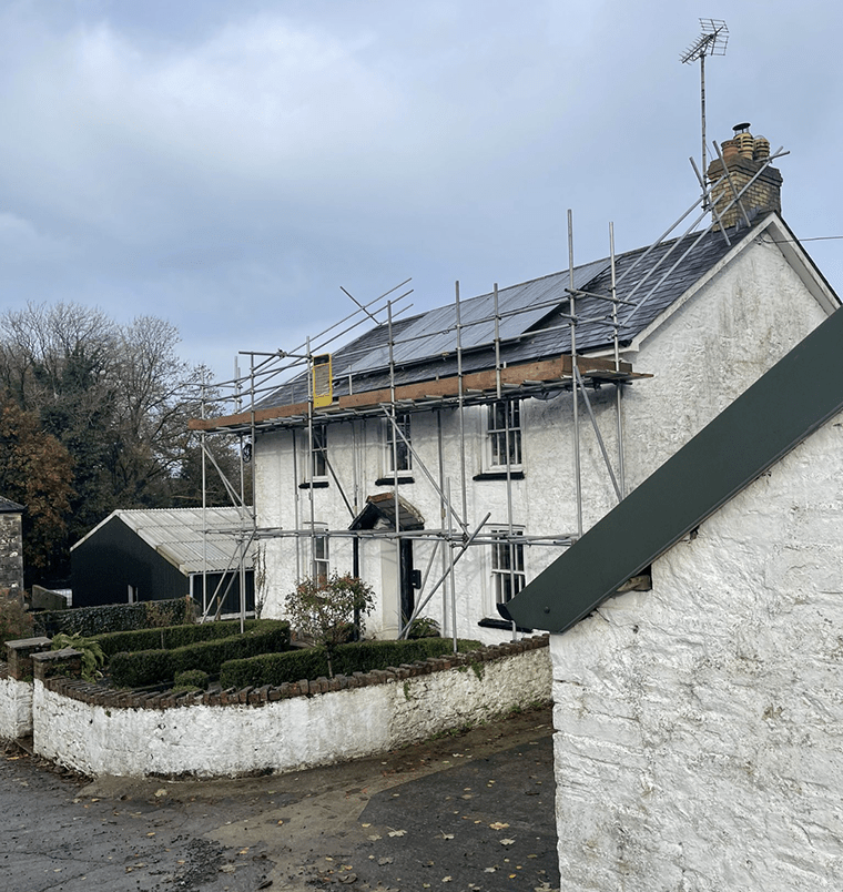 a house with scaffolding on the roof